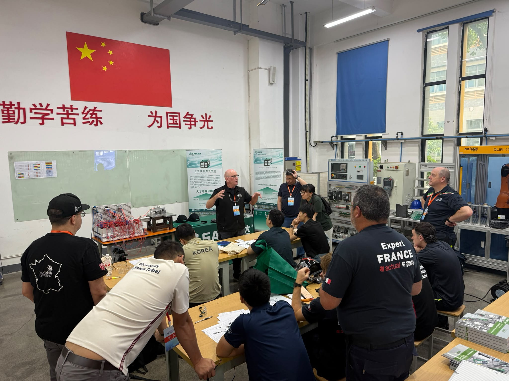 Sheridan Industrial Millwright program coordinator Craig Brazil provides instructions to a large group during a training event in China